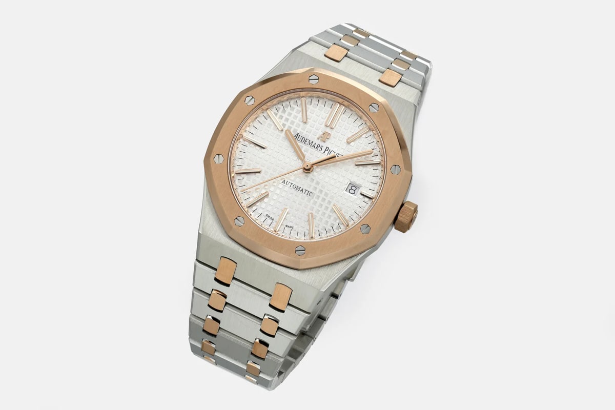 Angled three-quarter view on white, showing the octagonal bezel from the side, the crown at the right and the bracelet links running down from the lugs