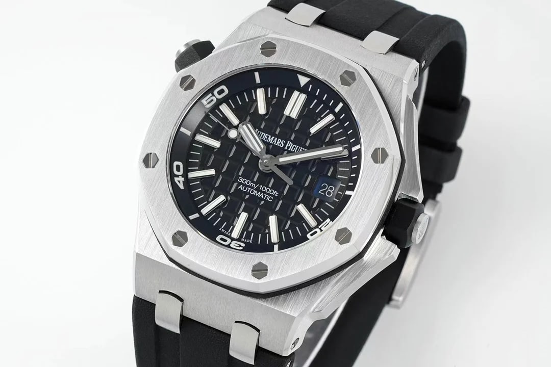 Three-quarter view of the case and dial: the octagonal bezel and its exposed screw heads, the crown at the right with the second crown at ten, and the black strap curving away