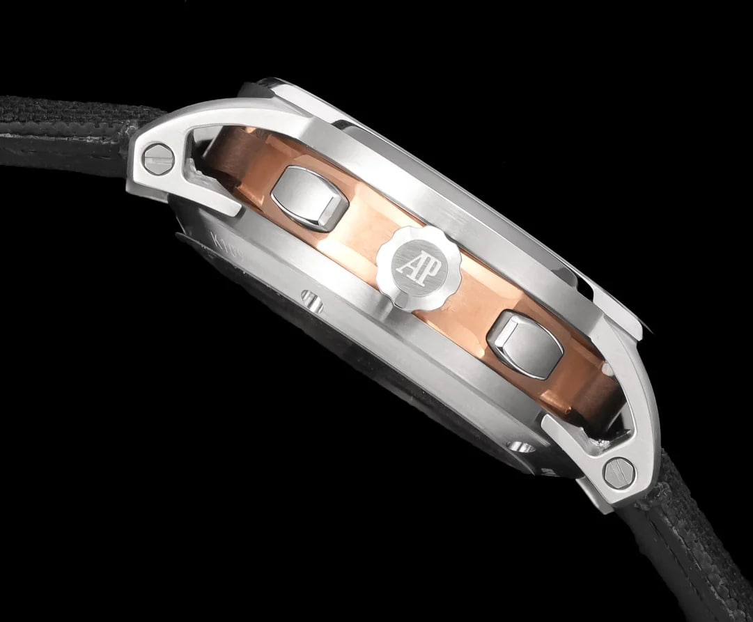 Case side view in detail: the flanks seen at a shallow angle, the eight-sided middle section stepping in beneath the round bezel, the crown at the centre of the flank and the strap running out of the frame