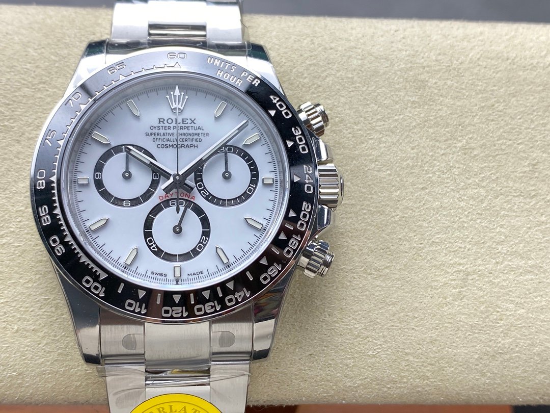 Product photograph of a steel chronograph with a white dial, three dark registers and a black tachymeter bezel