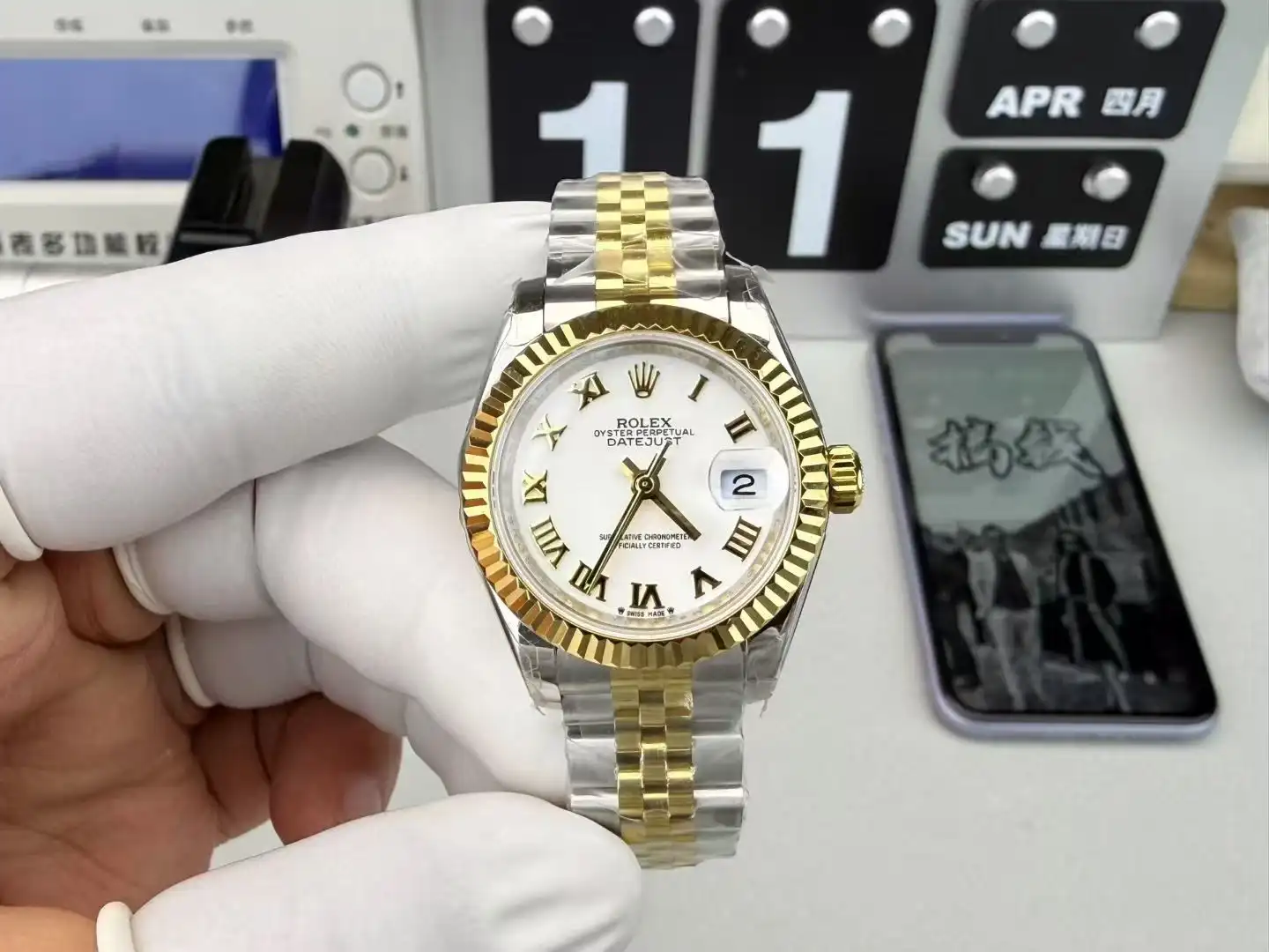 Reference photograph of a two-tone watch with a white dial and fluted bezel