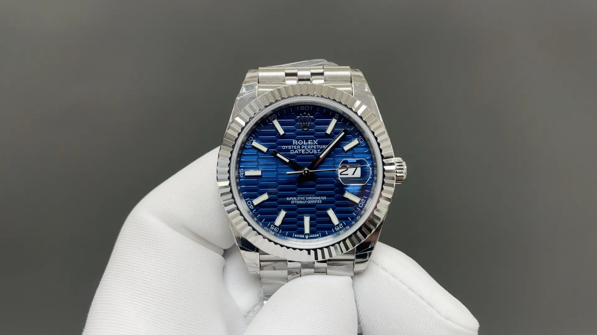 Product photograph 1 of 3: blue dial with a repeating fluted texture, a fluted bezel and a five-link bracelet