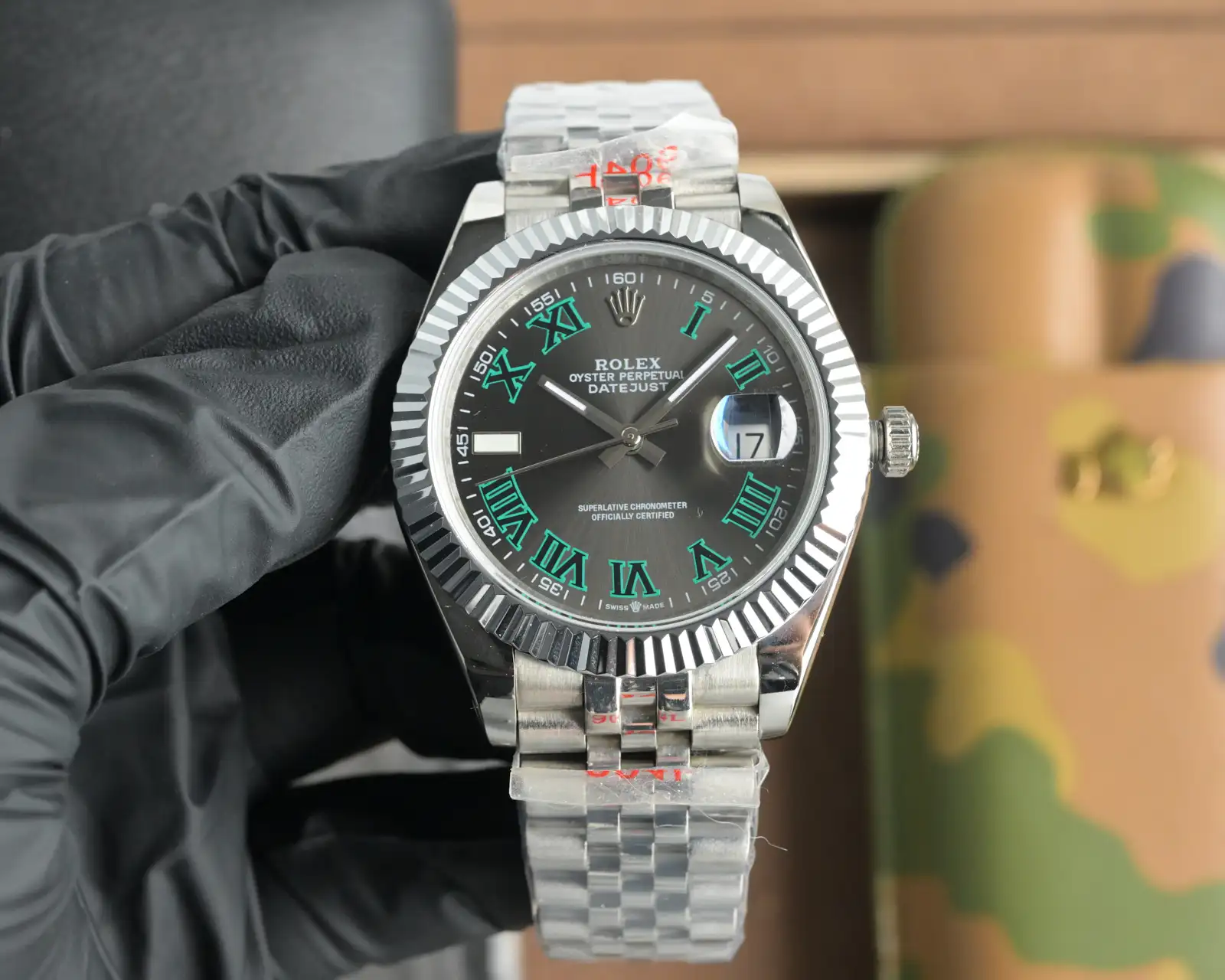 Product photograph 1 of 3: silver-tone watch with a slate dial, green-edged Roman numerals, a fluted bezel and a five-link bracelet