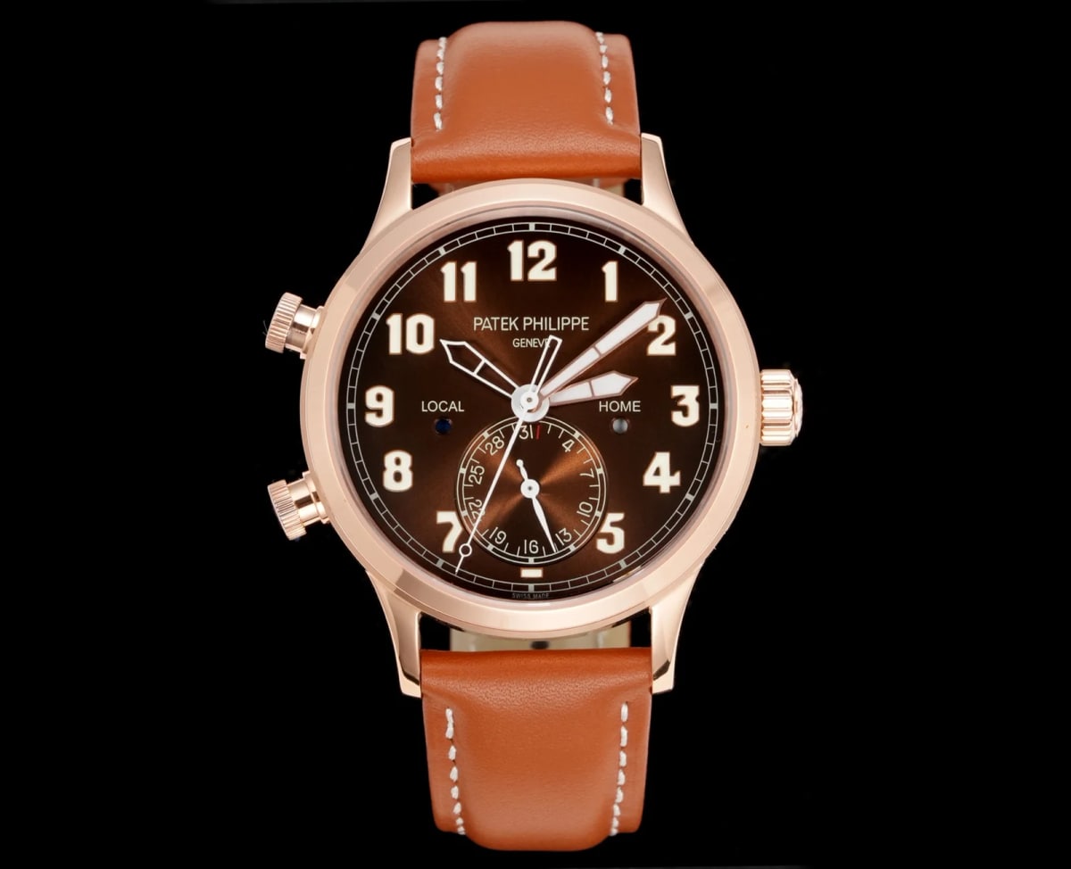 Brown pilot’s dial straight on in a rose-gold case, with large applied Arabic numerals, two time-zone markings above the centre, a date register above six o’clock and a leather strap below