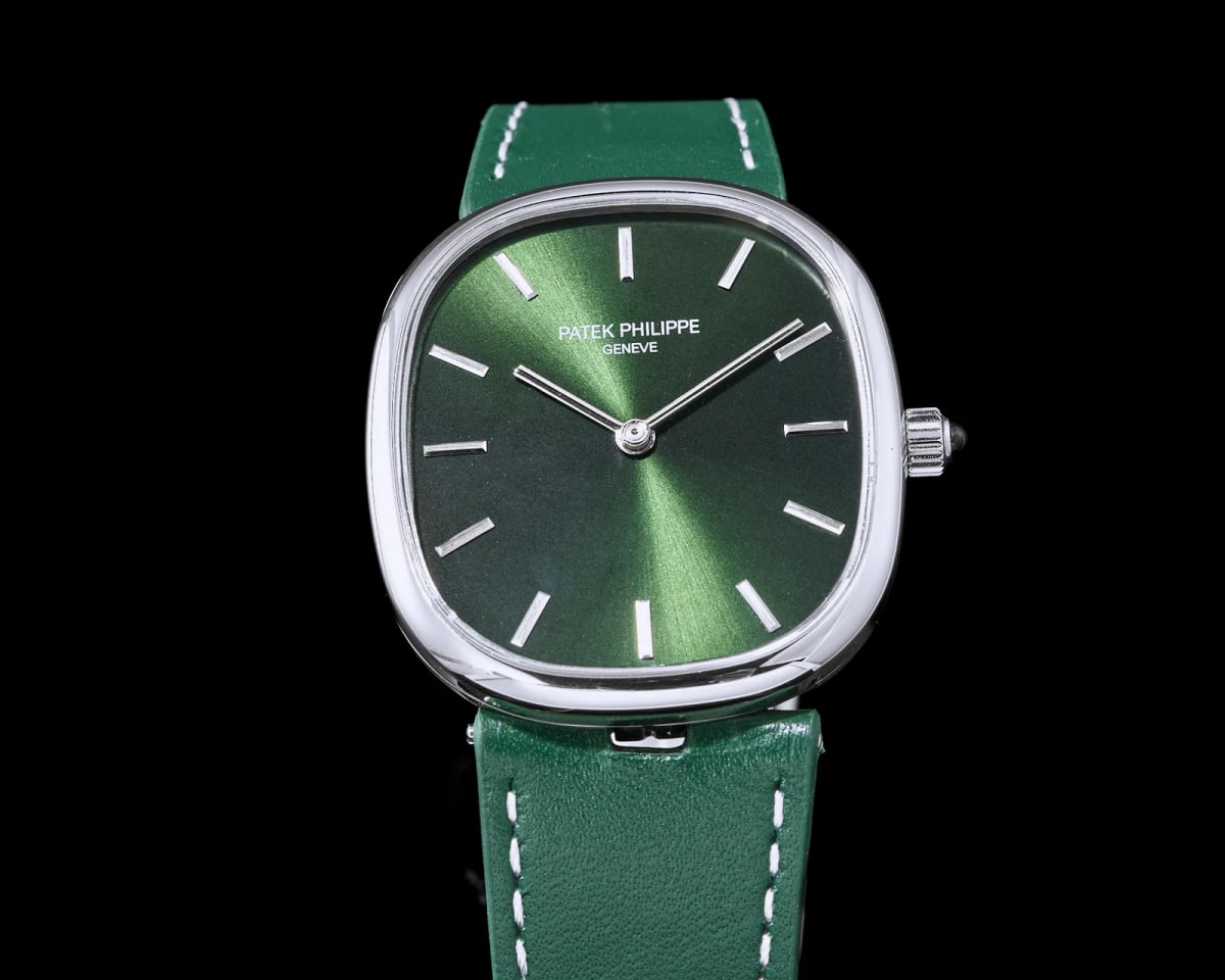 Close-up of the green dial with the sunburst rays radiating from the centre, the maker and city printed in two lines above it, slim applied baton markers and two narrow hands