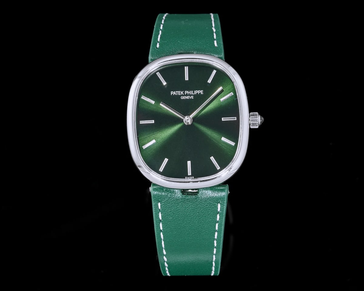 Green sunburst dial viewed straight on inside a polished rounded case, with the maker and city printed in two lines above the centre, slim applied baton markers, two hands and a green strap stitched in white
