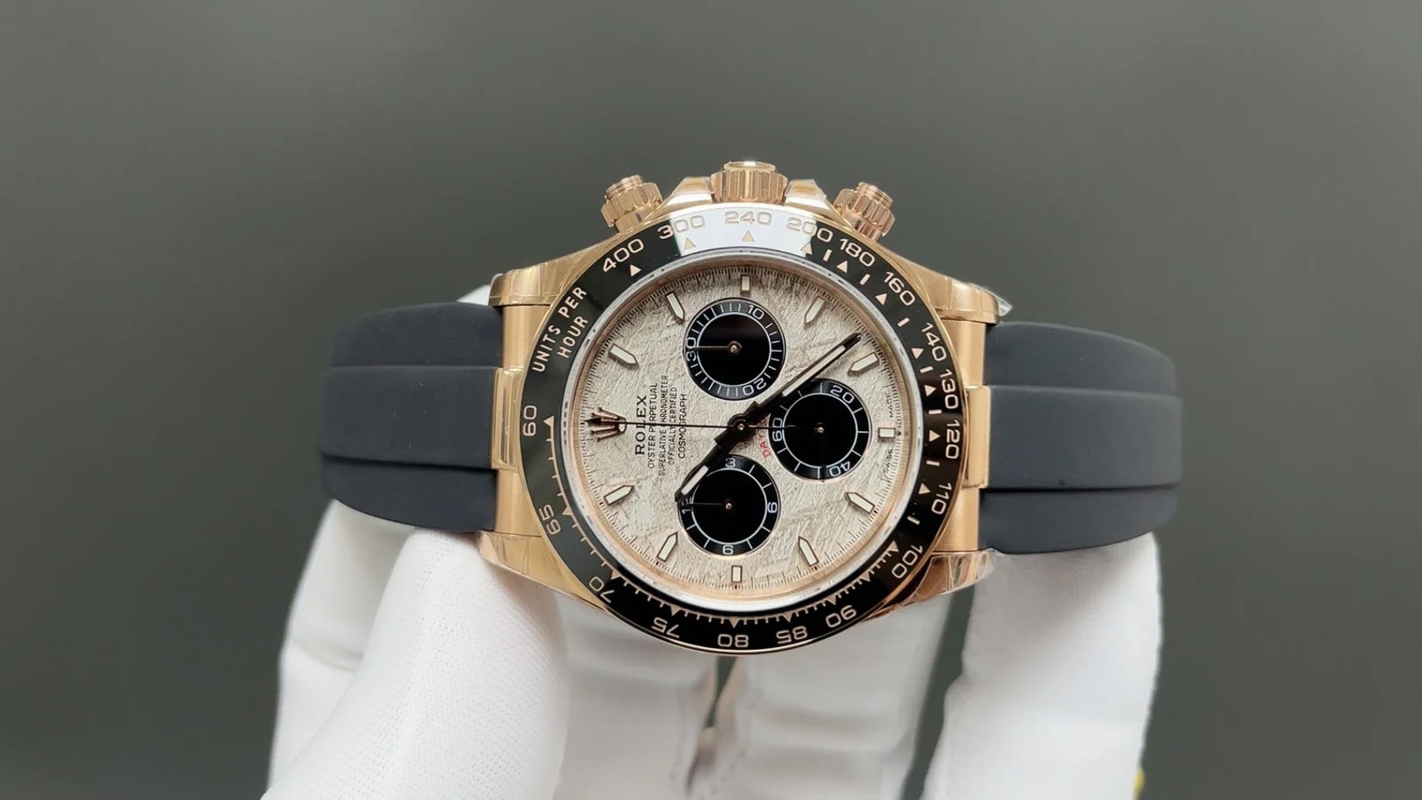 Bezel and dial front view showing the printed tachymeter values around the black insert and the counters set into the meteorite surface