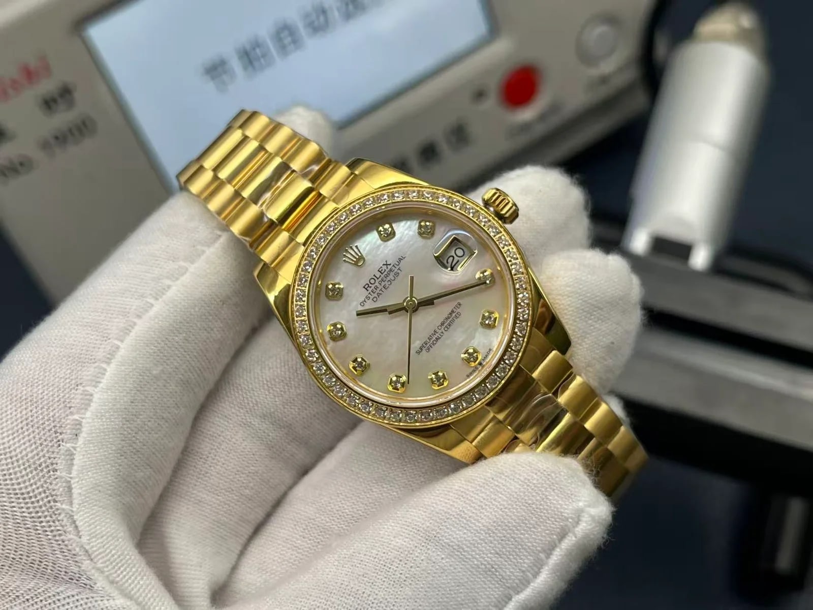 Three-quarter view of the gold case with the stone-set bezel turned towards the light and the date magnifier over the dial