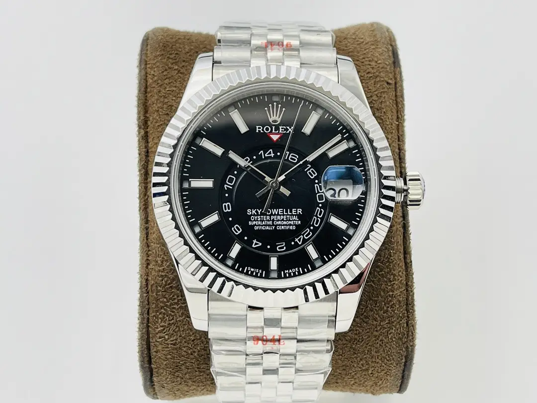 Reference photograph of a silver-tone watch with a black dial, a fluted bezel and a five-link bracelet